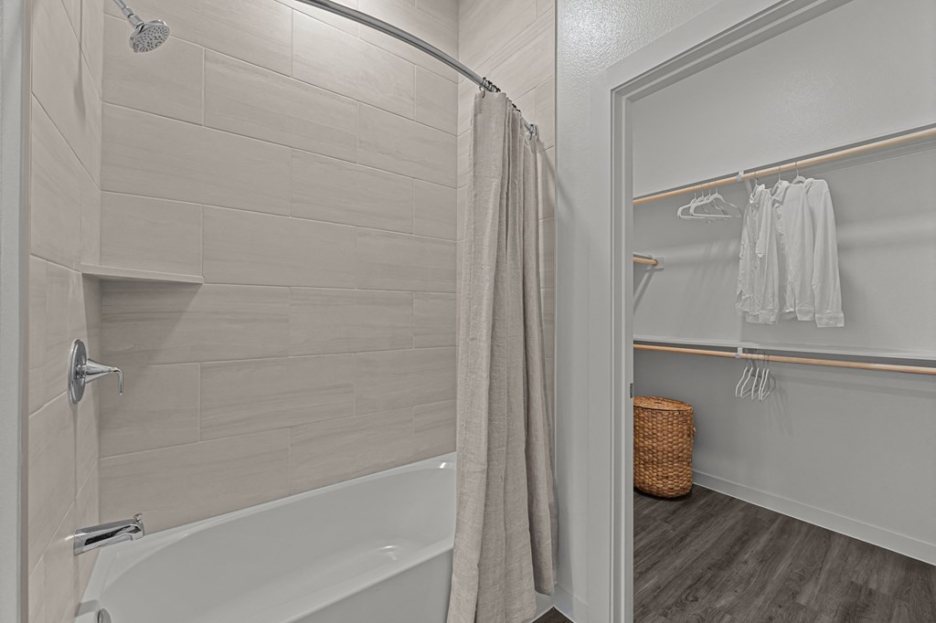 A bathroom with a white tub and a walk-in shower.