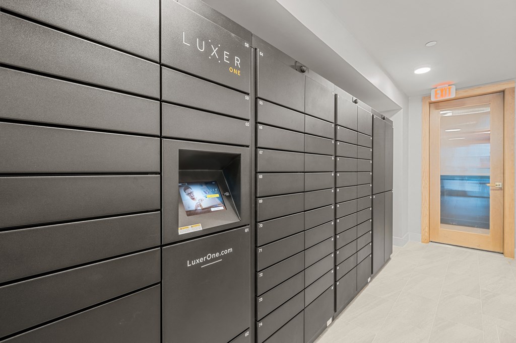 A row of black lockers with a sign that says "LUXER ONE" on the wall.
