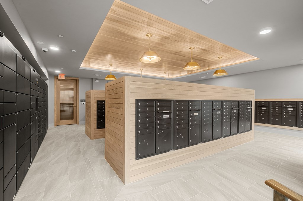 A modern kitchen with black cabinets and wooden accents.