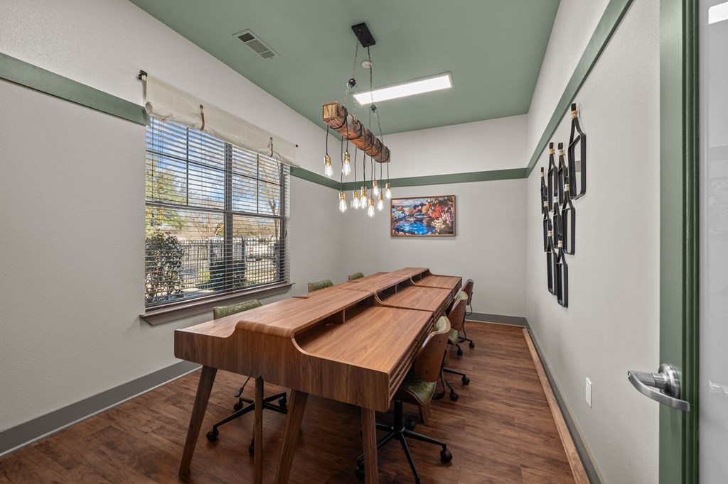 A conference room with a long table and chairs.