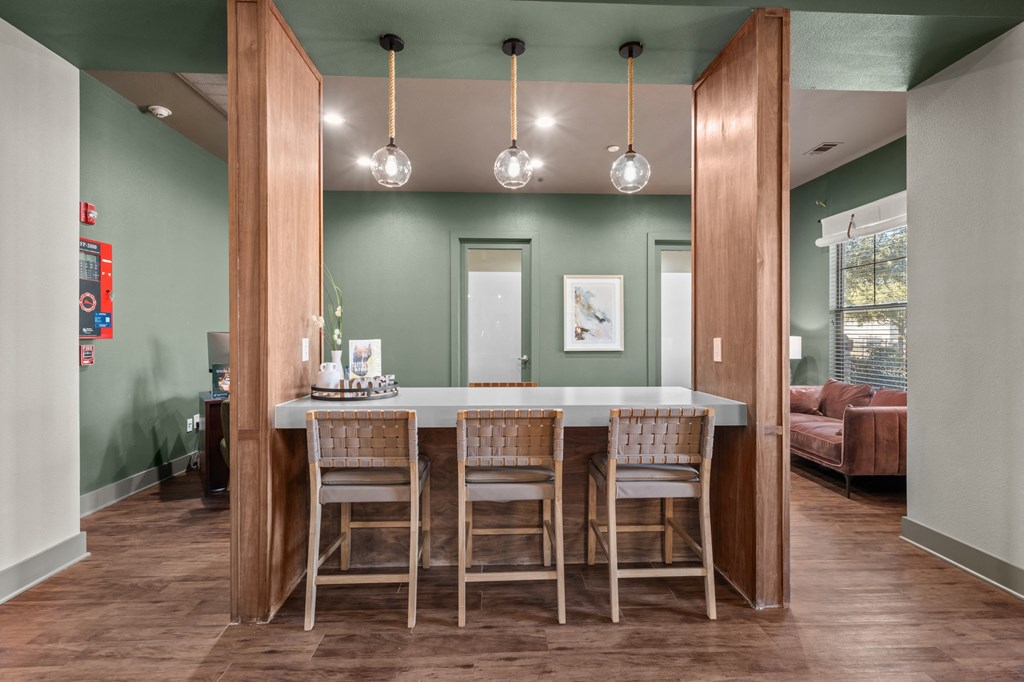A dining room with a table and chairs.