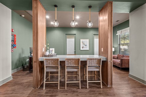 A dining room with a table and chairs.