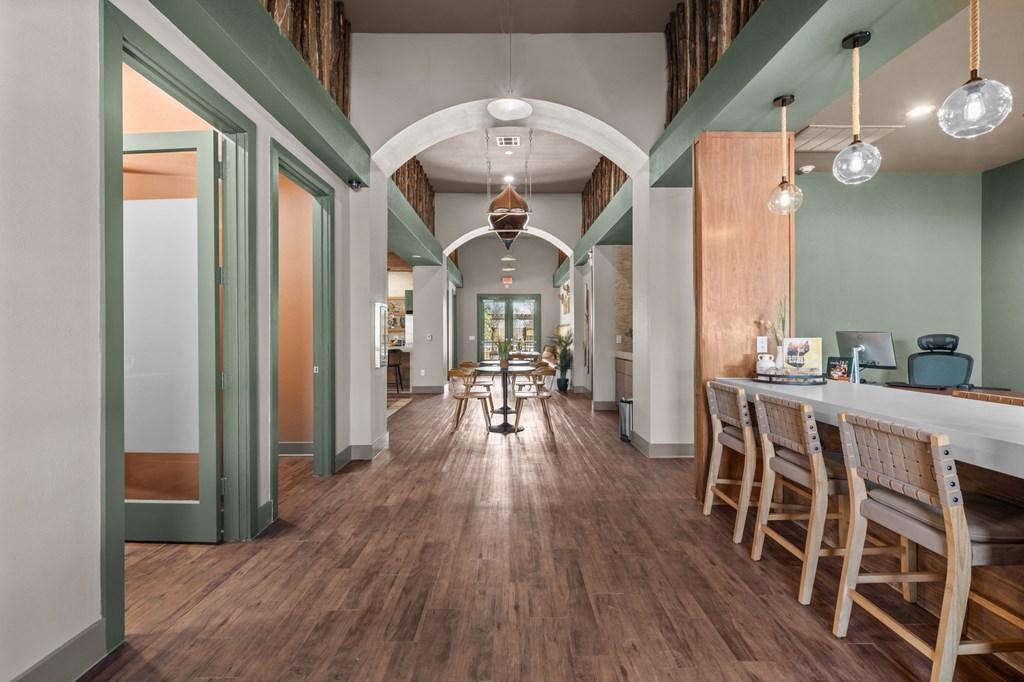 A long hallway with wooden floors and a white ceiling.