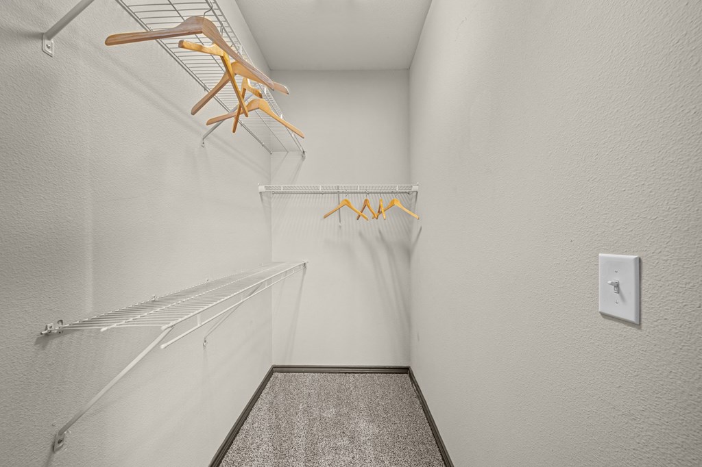 A hallway with a light switch on the wall.