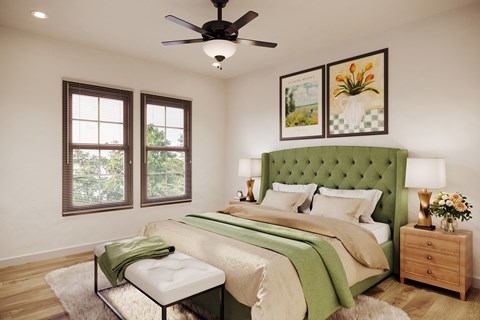 A bedroom with a green headboard and a white bed.