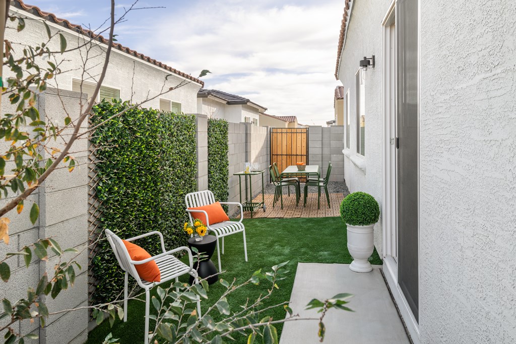 A small patio with a table and chairs.