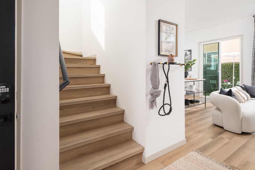A staircase with a rope hanging on the wall.