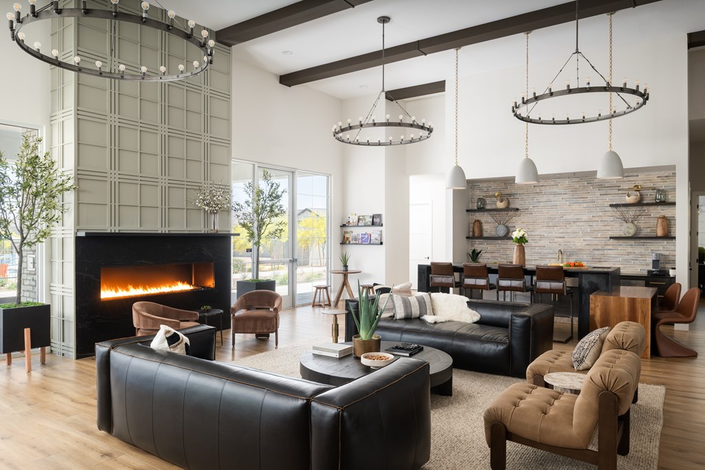 A modern living room with a fireplace and a variety of seating options.