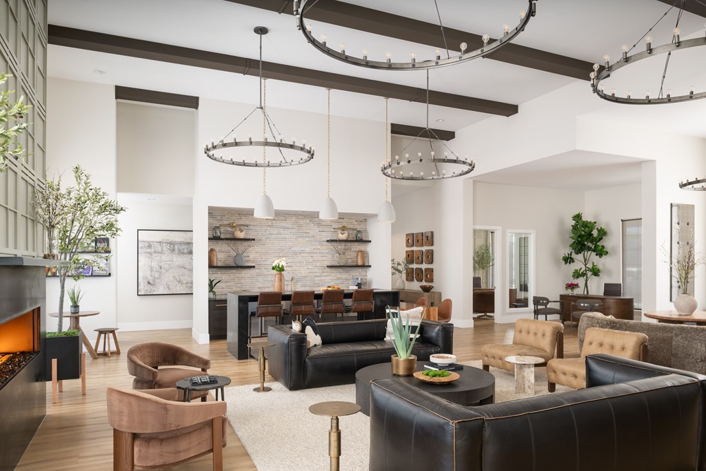 A modern living room with a fireplace and leather couches.