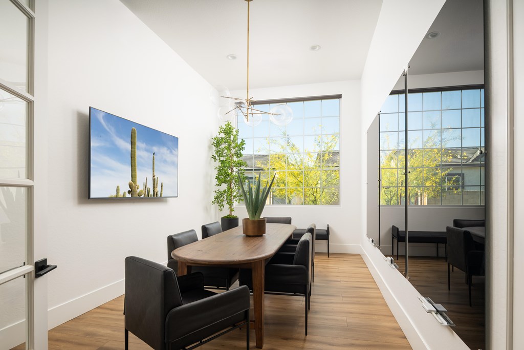 A modern dining room with a wooden table and chairs.