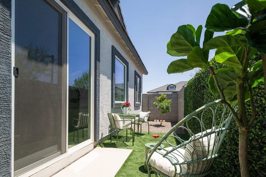 A patio with a chair and a table is shown.