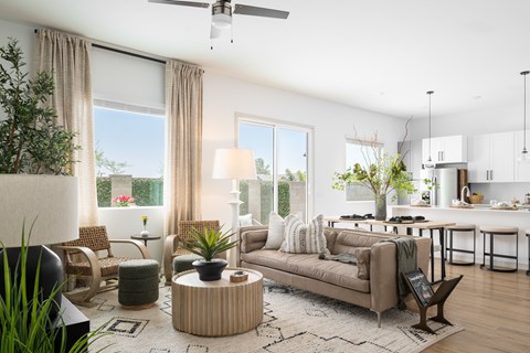 A modern living room with a sofa, chairs, and a coffee table.