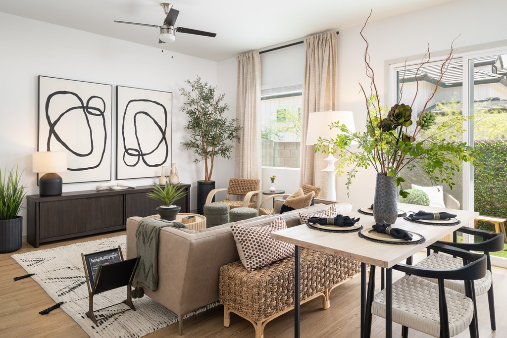 A modern living room with a brown sofa, a wooden coffee table, and a large abstract painting on the wall.