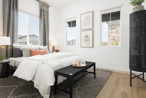 A bedroom with a large bed and a black coffee table.