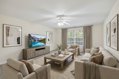 A living room with a television, couches, and a coffee table.