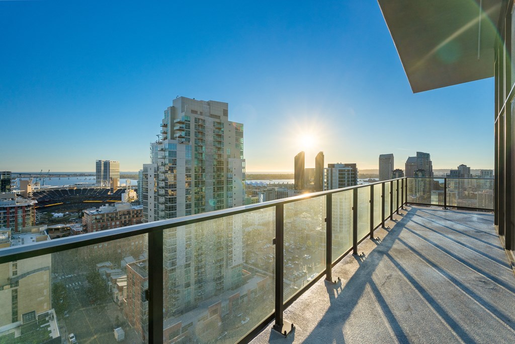 the view of the city from the balcony of a condo