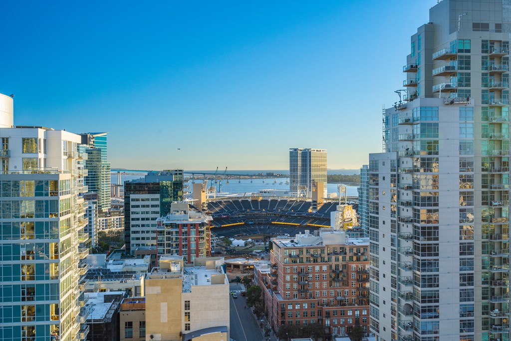 an aerial view of the city with a view of a baseball stadium