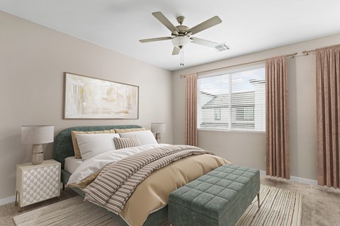 A bedroom with a large bed and a ceiling fan.