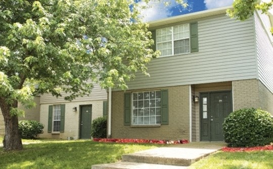 a house with a tree in front of it