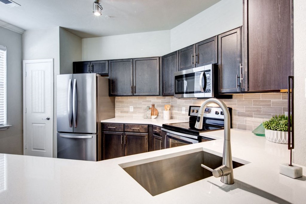 a kitchen with a sink and a refrigerator