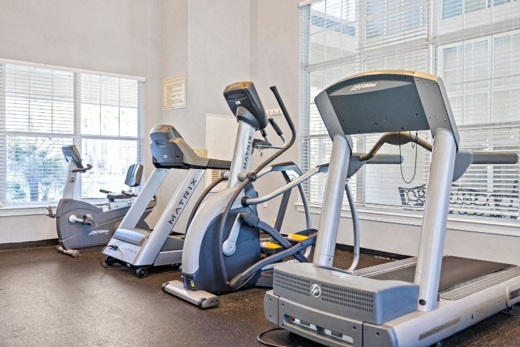 a gym with cardio machines and other exercise equipment