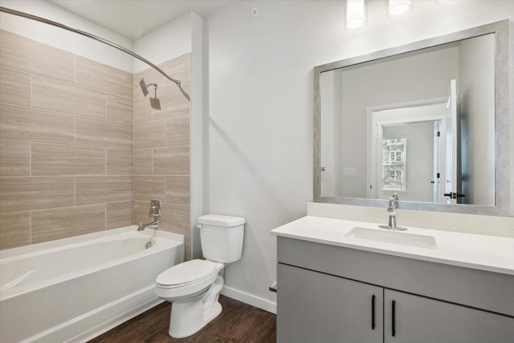 a bathroom with a sink toilet and a bath tub
