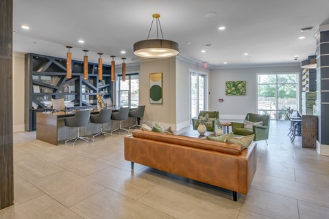 A modern living room with a long brown couch and a wooden coffee table.