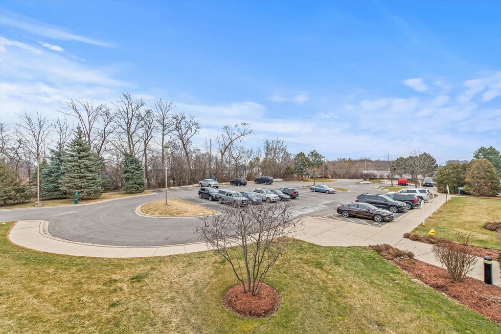 a parking lot with cars parked at the corner of a roundabout