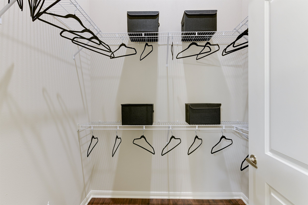 a closet with shoe racks and a white door