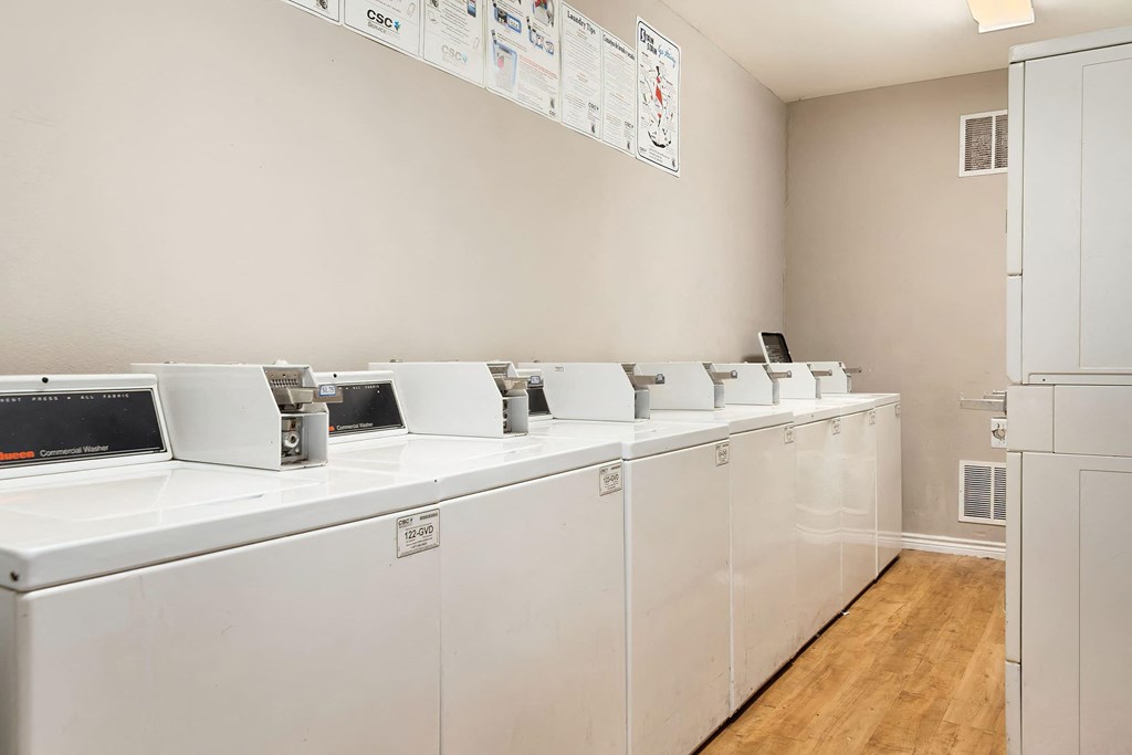 a laundry room with washers and dryers