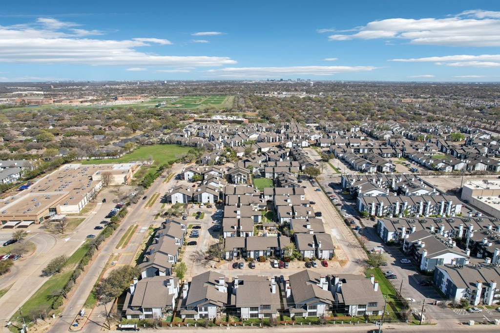 A suburban neighborhood with houses and a large open field.