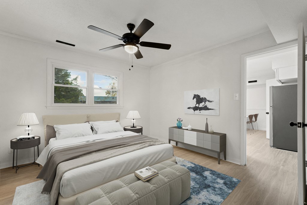 a bedroom with a large bed and a ceiling fan