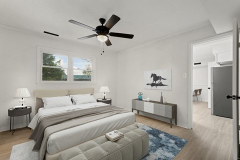 a bedroom with a large bed and a ceiling fan