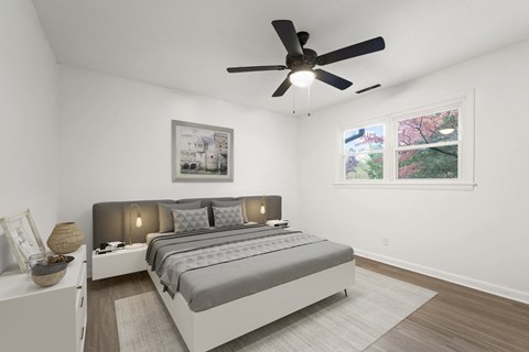 a bedroom with a bed and a ceiling fan