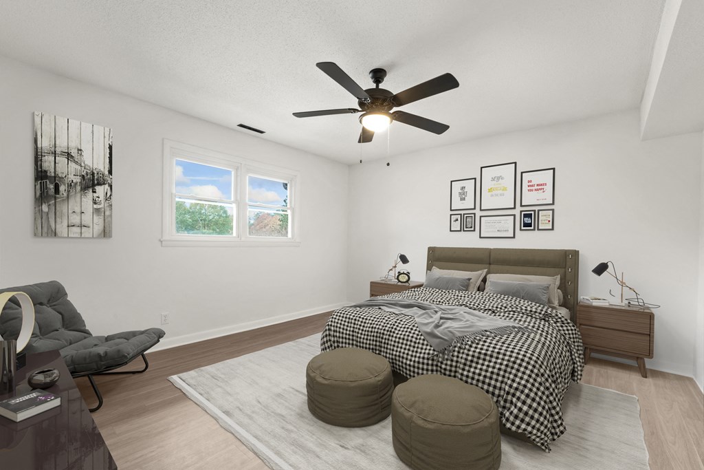 a bedroom with a bed and a ceiling fan