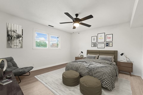a bedroom with a bed and a ceiling fan