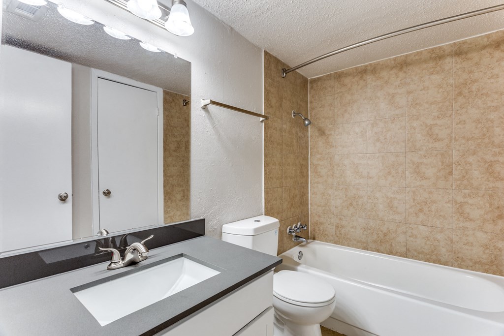a bathroom with a sink toilet and a bath tub