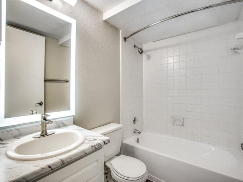 a bathroom with a sink toilet and a bath tub