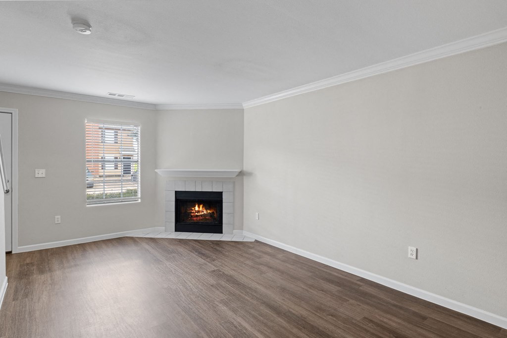 A room with a fireplace and a window.