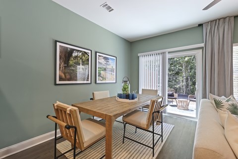 A dining room with a wooden table and chairs.