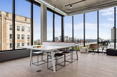 a dining room with a table and chairs in front of a window