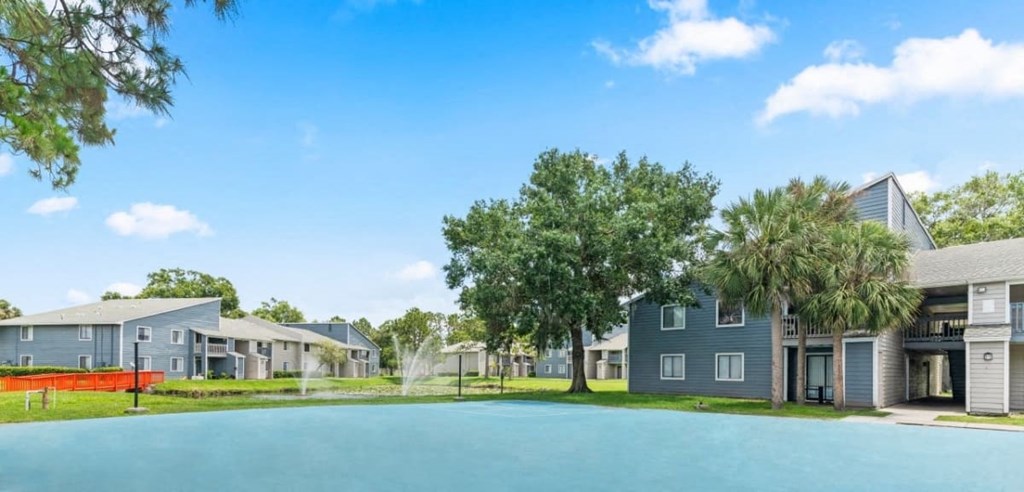 a large pool in front of a row of houses
