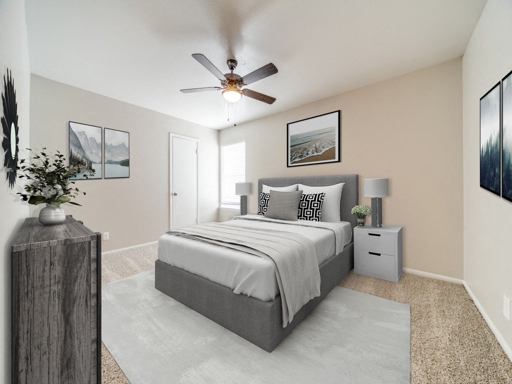 a bedroom with a bed and a ceiling fan