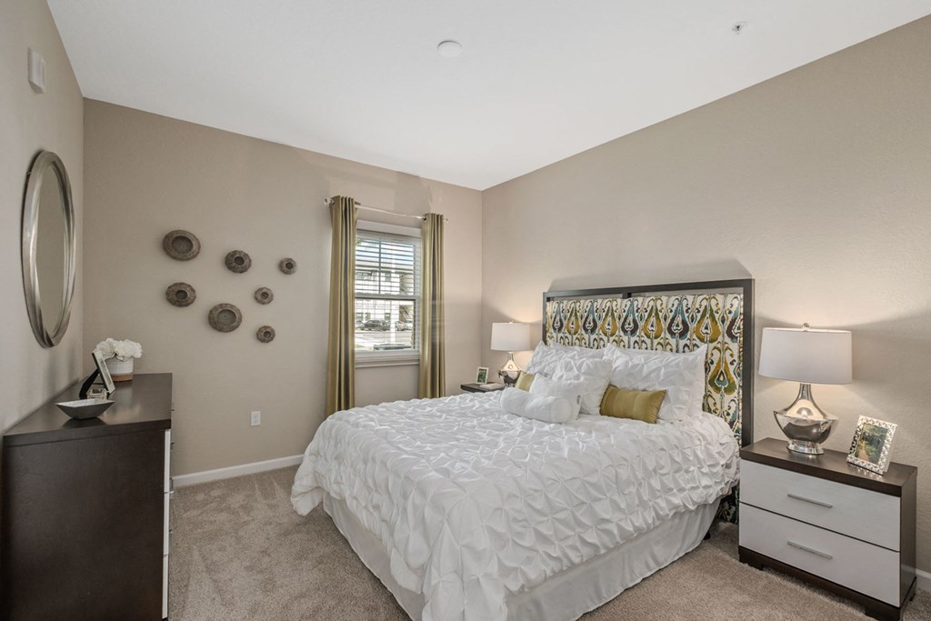 a bedroom with a large bed and a window