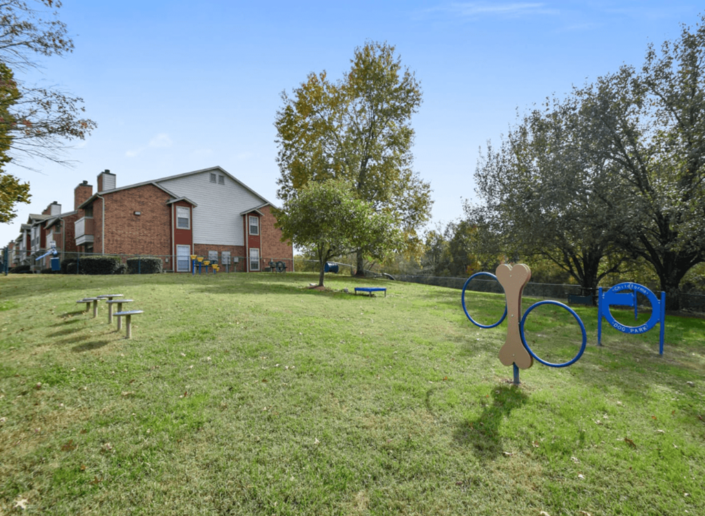 a large yard with a playground and a house