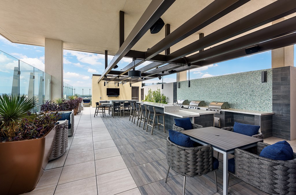 A patio with a table and chairs under a roof.