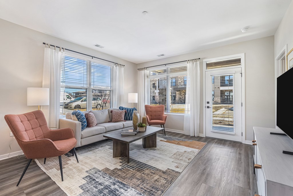 A living room with a couch, chairs, and a coffee table.