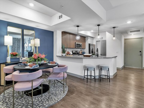 A modern kitchen with a dining table set for four.