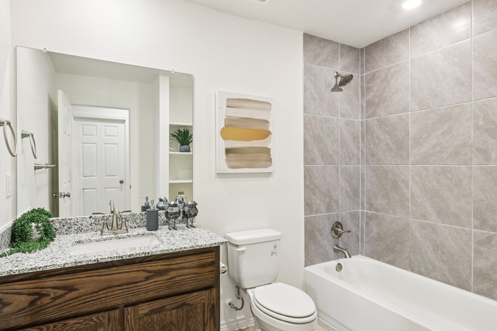 A bathroom with a white toilet and a white sink.
