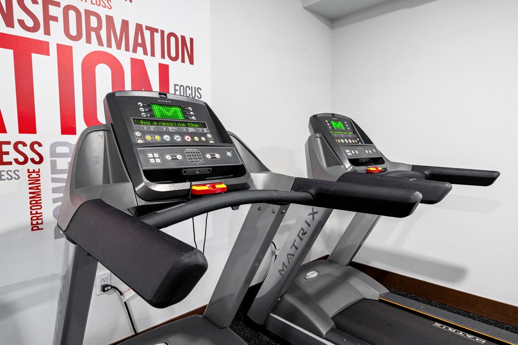 a close up of two treadmills in a gym